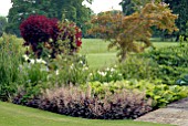 MIXED BORDER WITH HEUCHERA EBONY AND IVORY IN FOREGROUND AT OZLEWORTH PARK, GLOUCESTERSHIRE