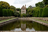FISHPOND,  YEW HEDGES AND TOWER HOUSE AT MAPPERTON IN DORSET
