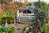 GARDEN SHED WITH SEAT, SACK TROLLEY AND GARDEN ROLLER