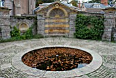 POOL WITH FALLEN AUTUMN LEAVES AT HESTERCOMBE GARDEN, SOMERSET.