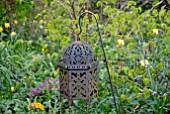 RUSTIC METAL LANTERN IN WOODLAND GARDEN