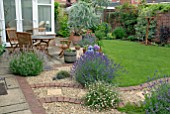 SUBURBAN BACK GARDEN WITH CONSERVATORY, BORDERS AND LAWN