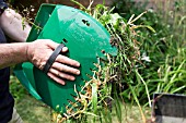 USING BIG HANDS TO CLEAR GARDEN RUBBISH