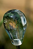 BUBBLE GLASS ORNAMENT SHOWING INTERESTING VIEW OF GARDEN