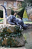 CAT SCULPTURE AT MILL DENE GARDEN,  BLOCKLEY,  MORETON IN MARSH,  GLOUCESTERSHIRE