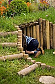 SUSIES GARDEN- CHILD PLAYING, ENTERING TUNNEL (DESIGNER: SUE JOLLANS) IN AID OF THE MENINGITIS TRUST, MALVERN SPRING GARDENING SHOW 2008