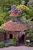 WISTERIA CLAD ENTRANCE TOWER AT STONE HOUSE COTTAGE GARDEN