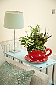 RED SPOTTED TEA CUP PLANTER, PLANTED WITH KALANCHOE, CALATHEA, IVY, CHAMAEDOREA ELEGANS, SPATHIPHYLLUM WALLISII, IN MODERN HOME