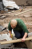 SAWING PLANKS WHILE CONSTRUCTING THE DEFRA GARDEN AT BIRMINGHAM BOTANICAL GARDENS