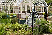 VIEW OF METAL AND PYRAMIDAL,   GREENHOUSE LEADING TO VEGETABLE AREA AT RYTON ORGANIC GARDEN,  MAY