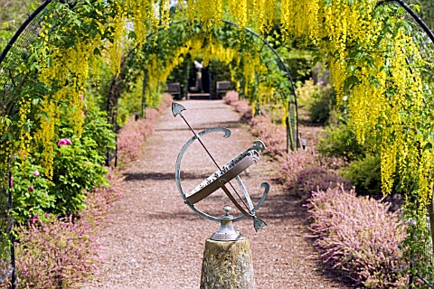 VIEW_WITH_ARMILLARY_AT_THE_LABURNUM_WALK_AT_THE_GARDEN_AT_THE_BANNUT__BRINGSTY__HEREFORDSHIRE__MAY