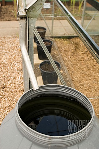 CONSERVING_RAINWATER_FROM_A_GREENHOUSE_GUTTER__AT_RYTON_ORGANIC_GARDEN__COVENTRY