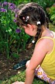 YOUNG GIRL GARDENING WITH TROWEL