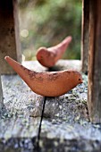 TERRACOTTA ORNAMENTS ON BIRD TABLE