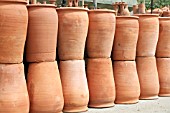 STACKS OF TERRACOTTA POTS ON DISPLAY AT A MARKET IN LEBANON
