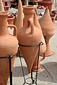 AMPHORA JARS ON WROUGHT IRON STANDS AT A MARKET IN LEBANON