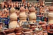 TERRACOTTA AND GLASS CONTAINERS ON DISPLAY AT A MARKET STALL IN LEBANON