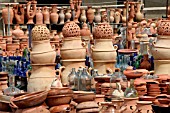 TERRACOTTA AND GLASS CONTAINERS ON DISPLAY AT A MARKET STALL IN LEBANON