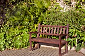 WOODEN BENCH IN A QUIET CORNER OF PENLEE MUSEUM GARDENS, PENZANCE