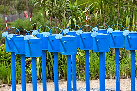 COLOURFUL_SCULPTURE_OF_BLUE_WATERING_CANS