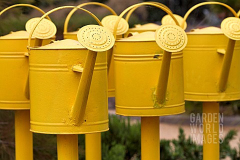 WHIMSICAL_SCULPTURE_OF_YELLOW_WATERING_CANS