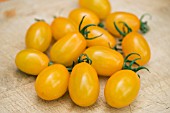 TOMATO GOLDEN SWEET ON CHOPPING BOARD