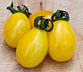 TOMATO YELLOW PEAR (ON A CHOPPING BOARD)