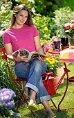 LADY ENJOYING AND RELAXING IN THE GARDEN