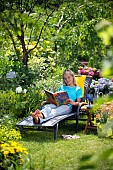 LADY ENJOYING AND RELAXING IN THE GARDEN