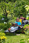 LADY ENJOYING AND RELAXING IN THE GARDEN