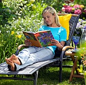 LADY ENJOYING AND RELAXING IN THE GARDEN