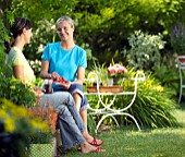 PEOPLE PERSONS ENJOYING BEING RELAXING IN THE GARDEN