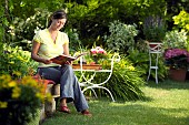 LADY ENJOYING AND RELAXING IN THE GARDEN