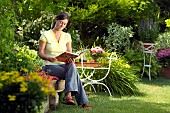 LADY ENJOYING AND RELAXING IN THE GARDEN