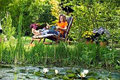 LADY ENJOYING AND RELAXING IN THE GARDEN