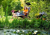 LADY ENJOYING AND RELAXING IN THE GARDEN