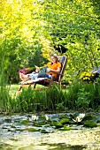 LADY ENJOYING AND RELAXING IN THE GARDEN