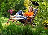 LADY ENJOYING AND RELAXING IN THE GARDEN