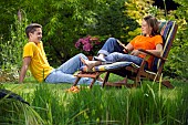 PEOPLE PERSONS ENJOYING BEING RELAXING IN THE GARDEN