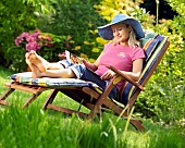 LADY ENJOYING AND RELAXING IN THE GARDEN