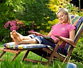 LADY ENJOYING AND RELAXING IN THE GARDEN