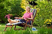 LADY ENJOYING AND RELAXING IN THE GARDEN