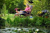 LADY ENJOYING AND RELAXING IN THE GARDEN