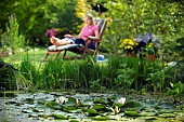 LADY ENJOYING AND RELAXING IN THE GARDEN