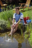 USING NET TO CLEAN POND, WATER GARDEN MAINTENANCE WORKS.