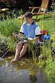 READING WITH FEET IN GARDEN POND