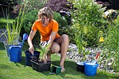 PLANTING UP BASKETS FOR POND