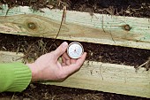 CHECKING TEMPERATURE OF COMPOST