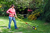 LAWN ACTION LADY USING EXTENDING SCARIFIER