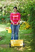 LAWN ACTION LADY SPREADING FERTILISER